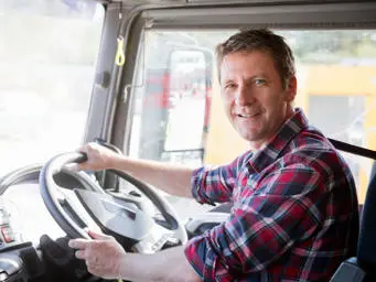 Male lorry driver in his cab