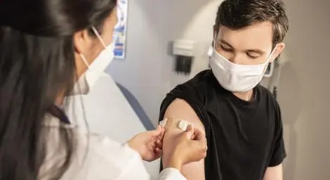 School nurse giving injection to a student