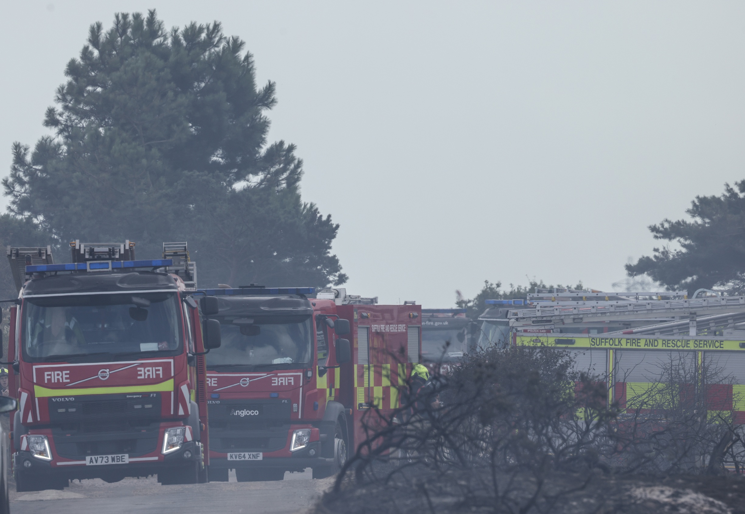 four appliances parked in burned out heathland