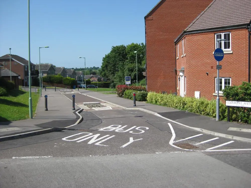 A quieter route for cycliests - a bus lane going along Clermont Avenue in Sudbury, houses on the right.