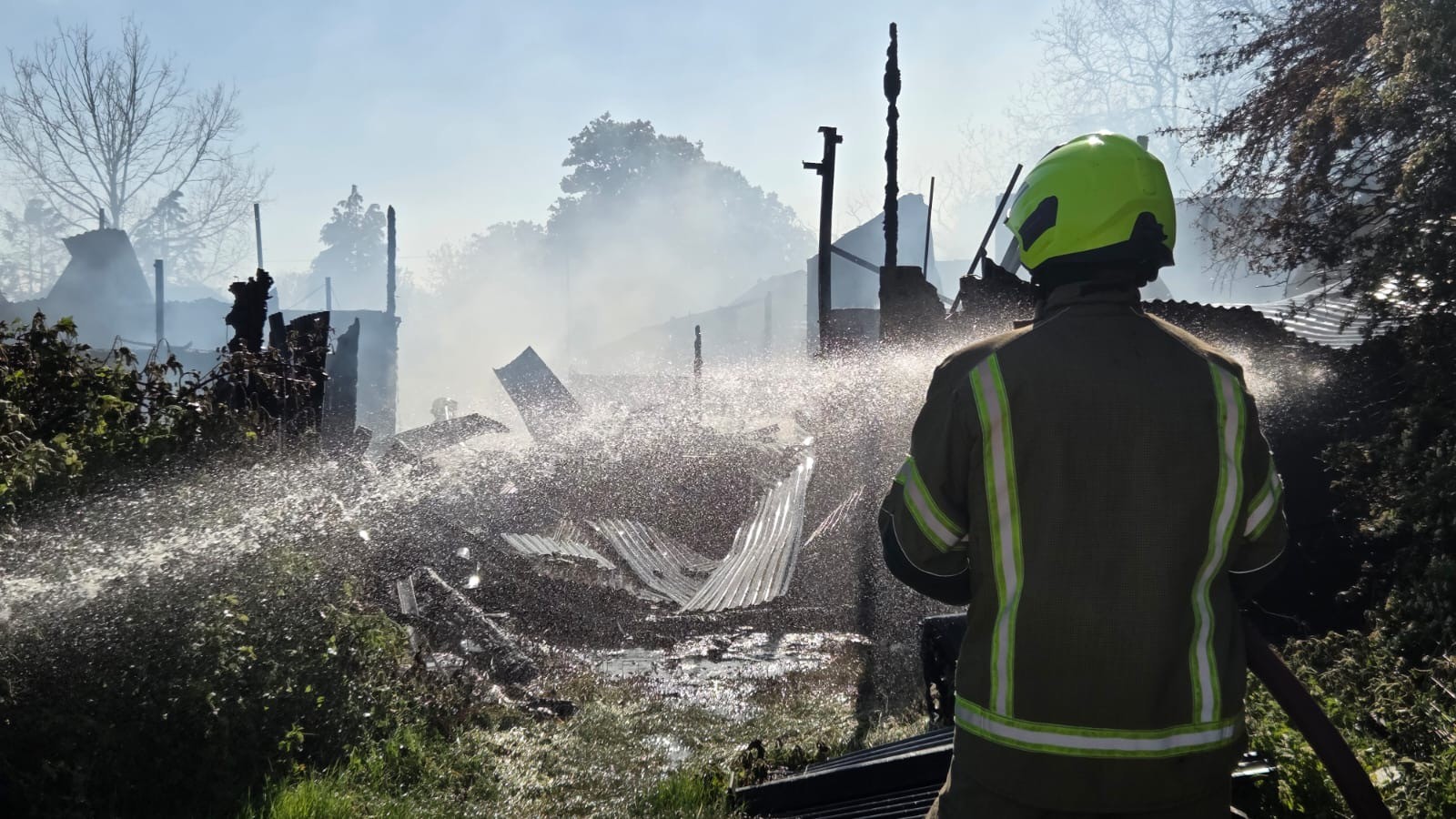 Firefighter tackling barn fire in Wetherden