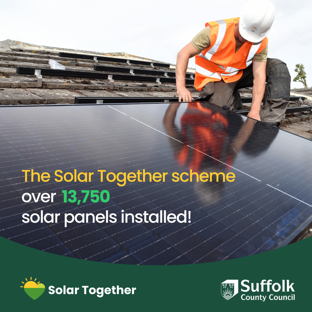 an engineer fitting solar panels on a roof. the solar together scheme over 13,750 solar panels installed!