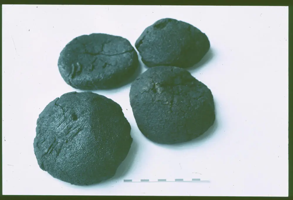 Four burnt bread rolls