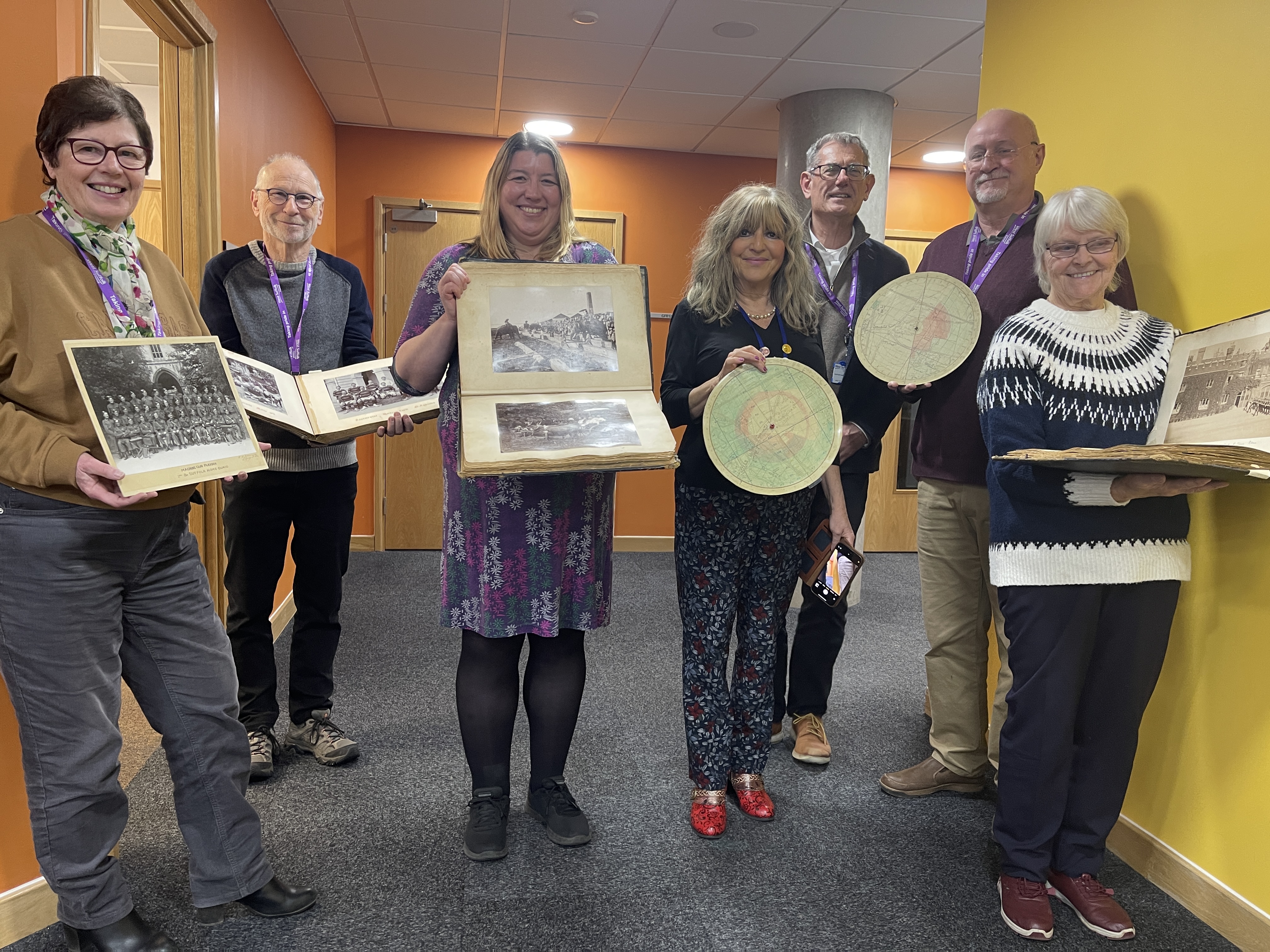 Group of people holding items from the regiment 