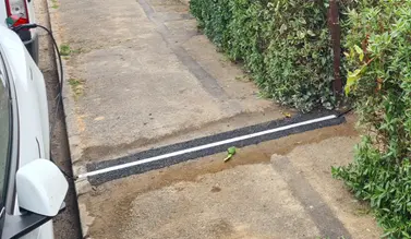 Charge-Gully electric vehicle installation constructed within a pavement