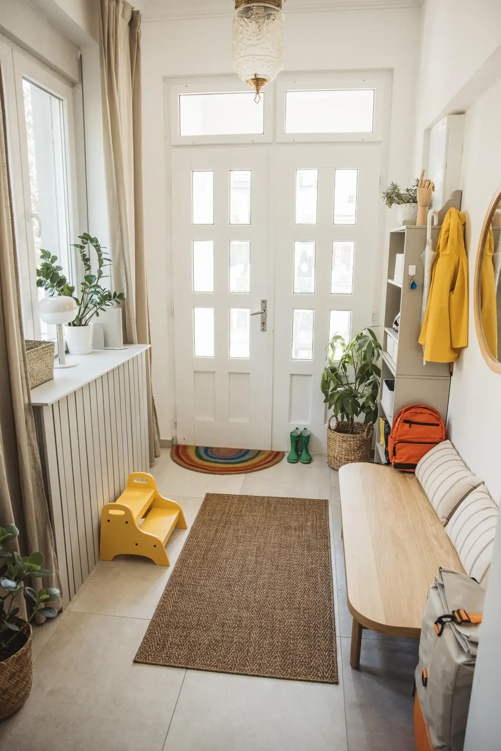 Example of a hallway with a bench to the side and steps up to reach the hooks