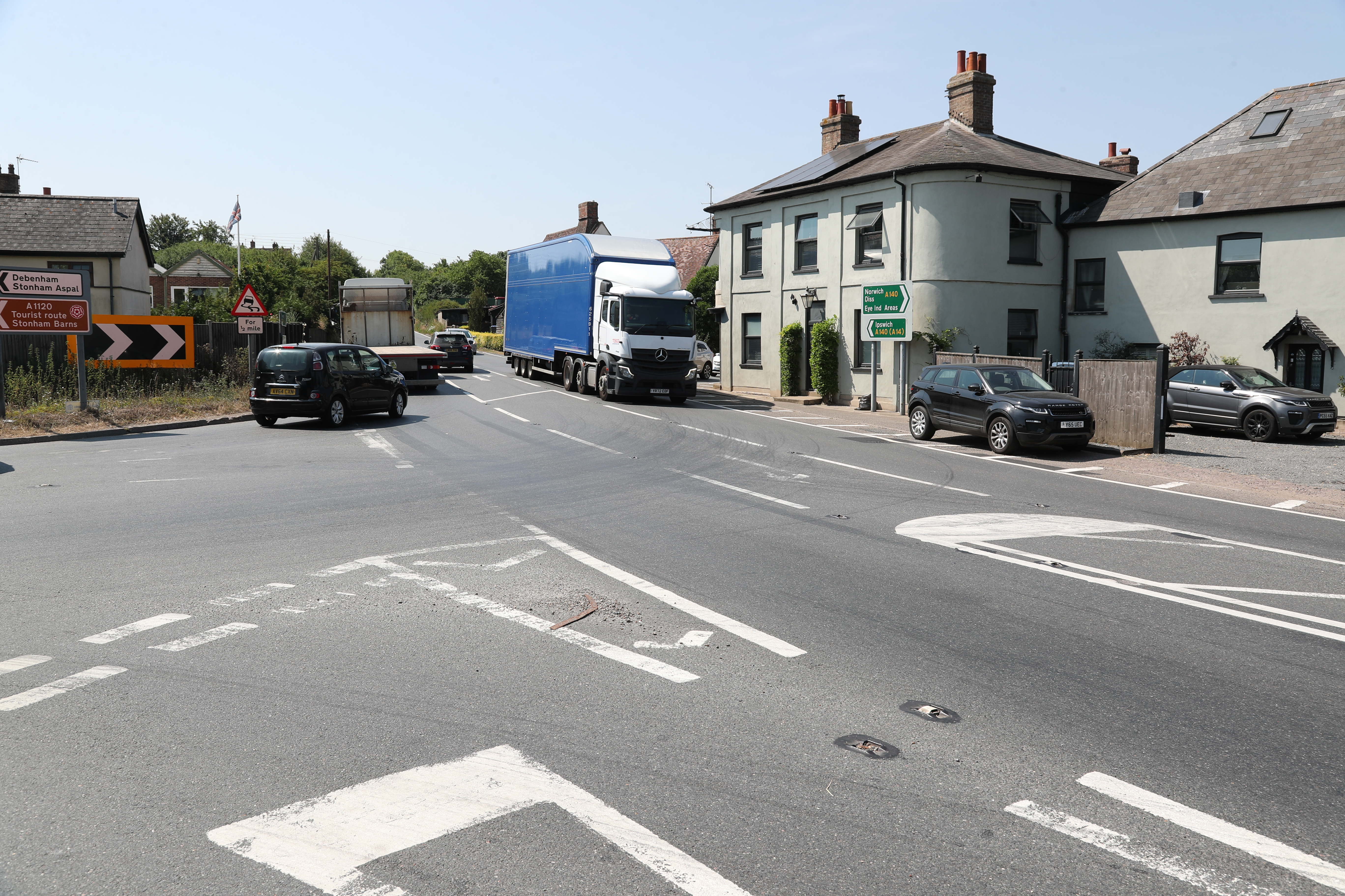The A140/ A1120 staggered junction with cars and lorries showing congestion. 