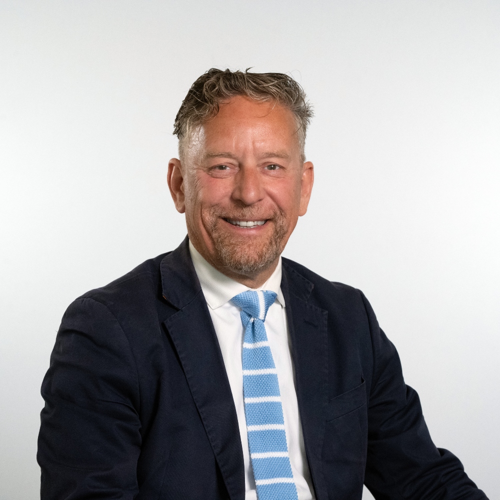Councillor Adrian Whittle wearing suit and tie