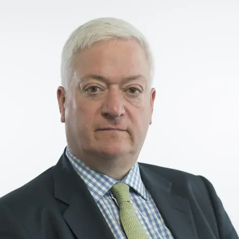 Alexander Nicoll, Councillor, wearing dark suit jacket and check shirt with a patterned tie.