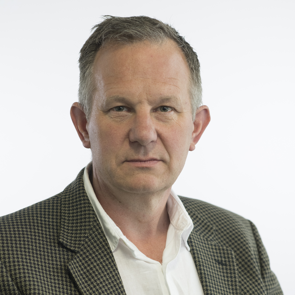 Image of Andy Mellen wearing suit jacket and white shirt