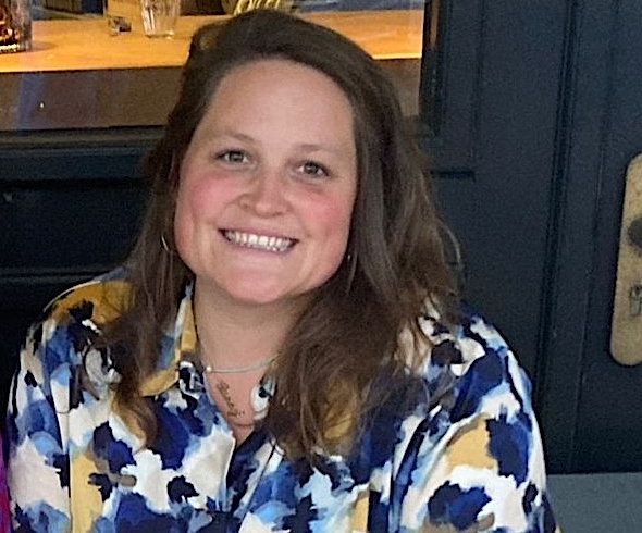 Annie, a Skills Bootcamp Learner, is smiling proudly in the photo