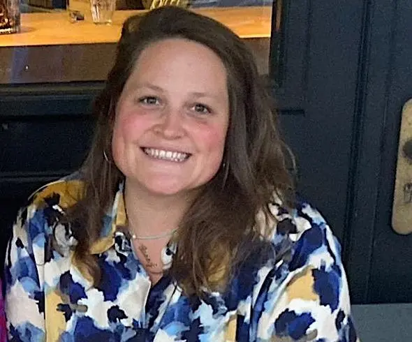 Annie, a Skills Bootcamp Learner, is smiling proudly in the photo