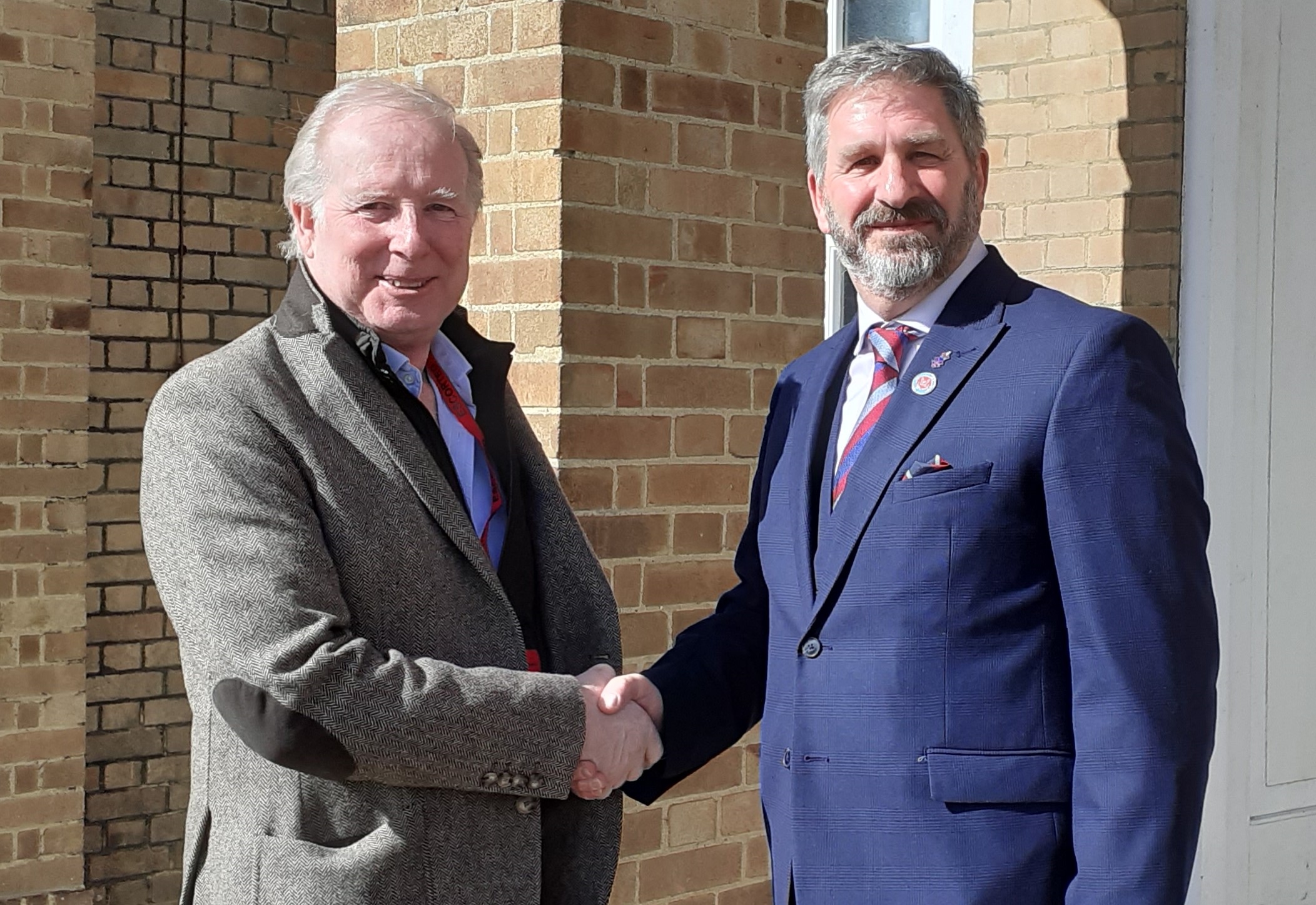 Outgoing Suffolk Armed Forces Commissioner Lee Holloway, left, shaking hands with Andy Smith 