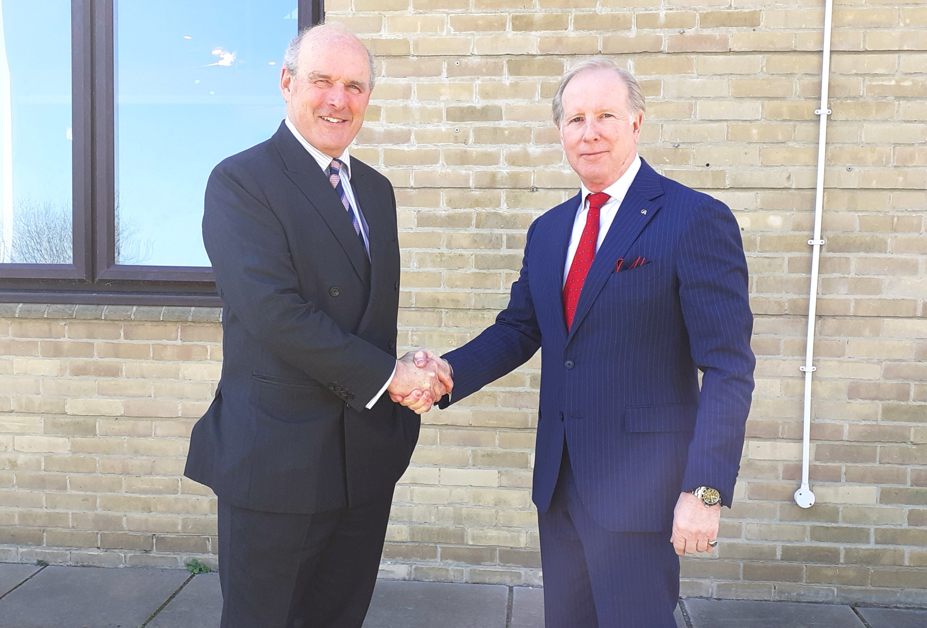 Colonel (retd) John Ogden, left, and Lee Holloway shaking hands outside a building