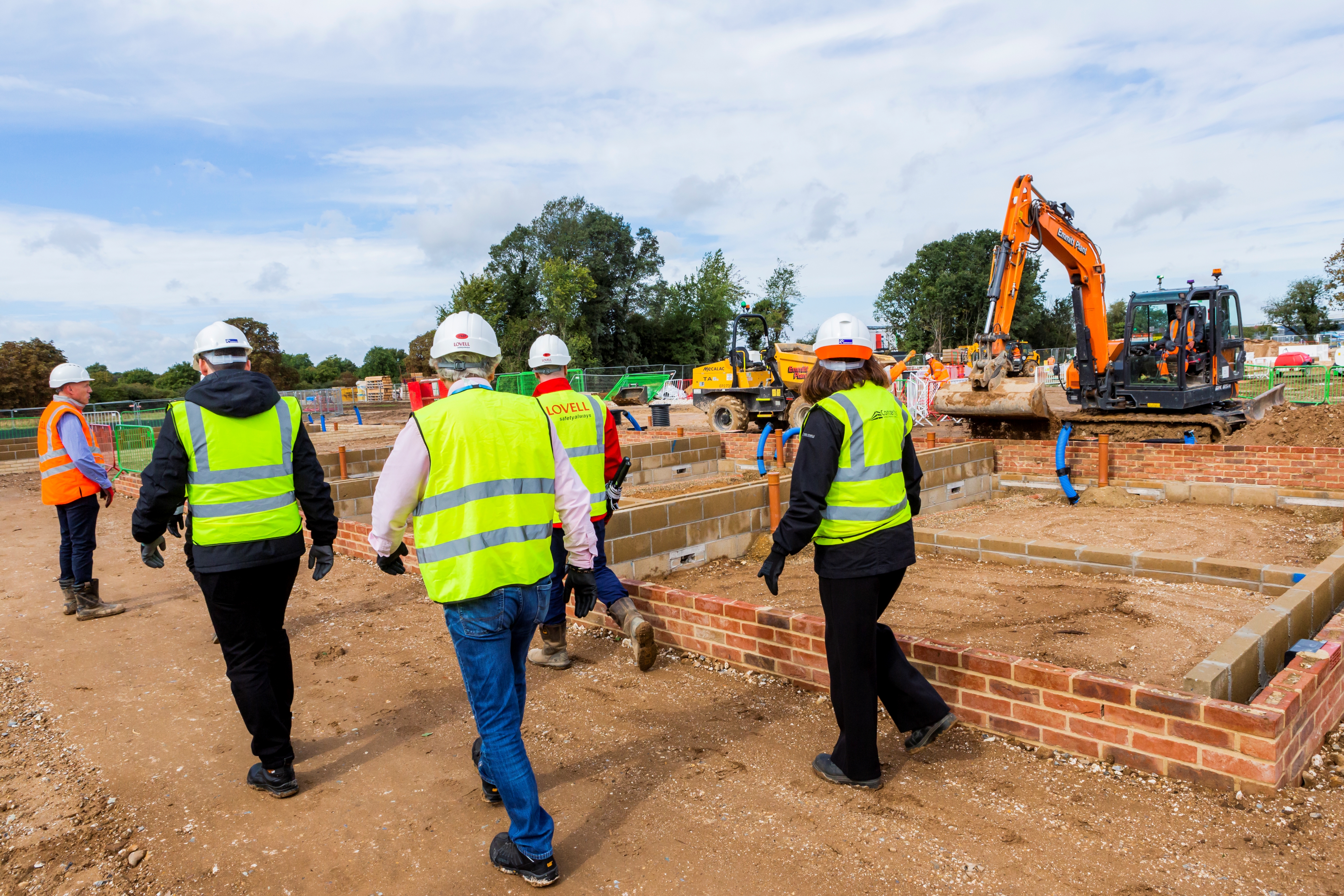 People in hi vis clothing being shown around the construction site