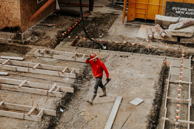 construction worker walking across an area of construction ground works
