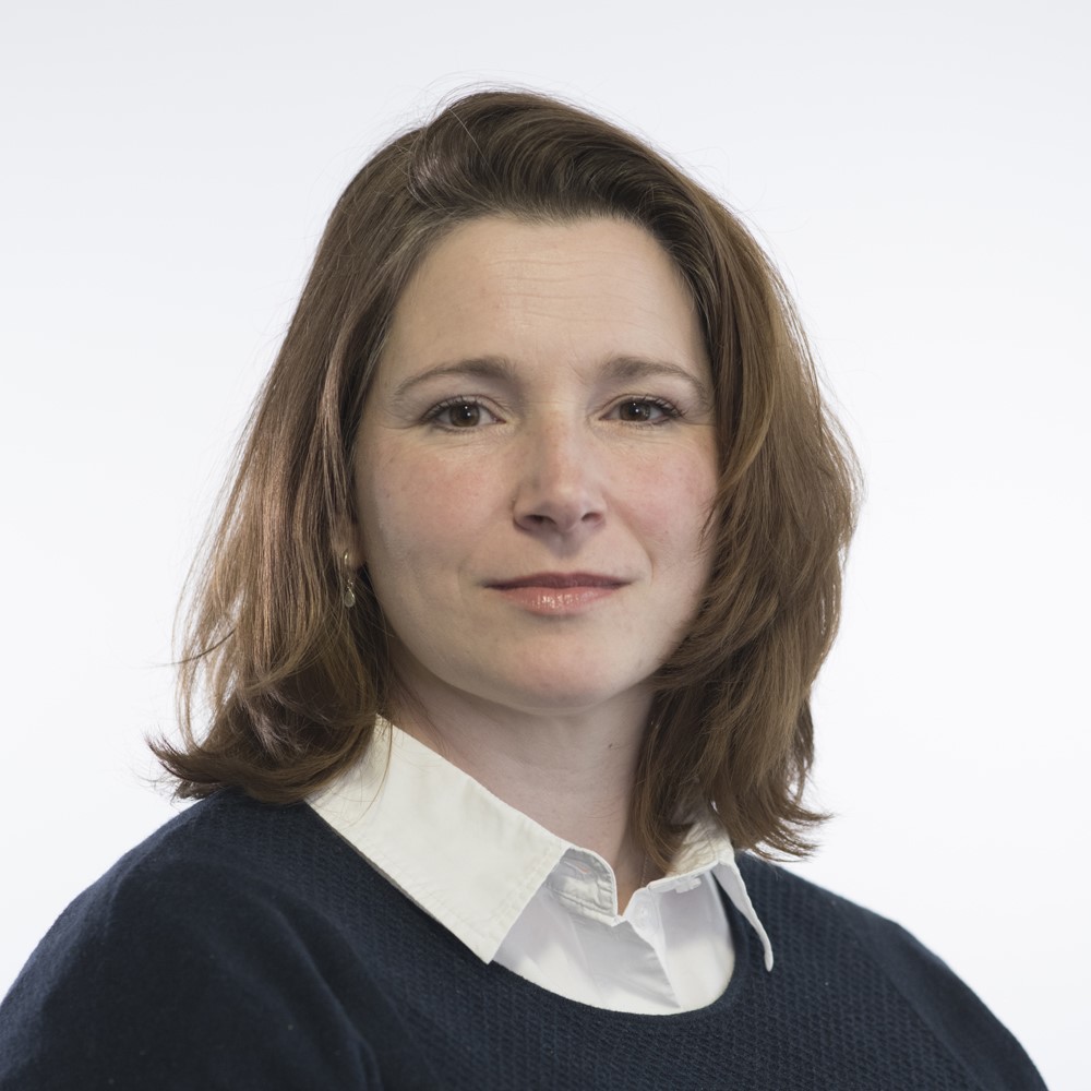 Image of Bobby Bennet - councillor, wearing a white blouse and blue jumper. Hair is cut short at the shoulder. 