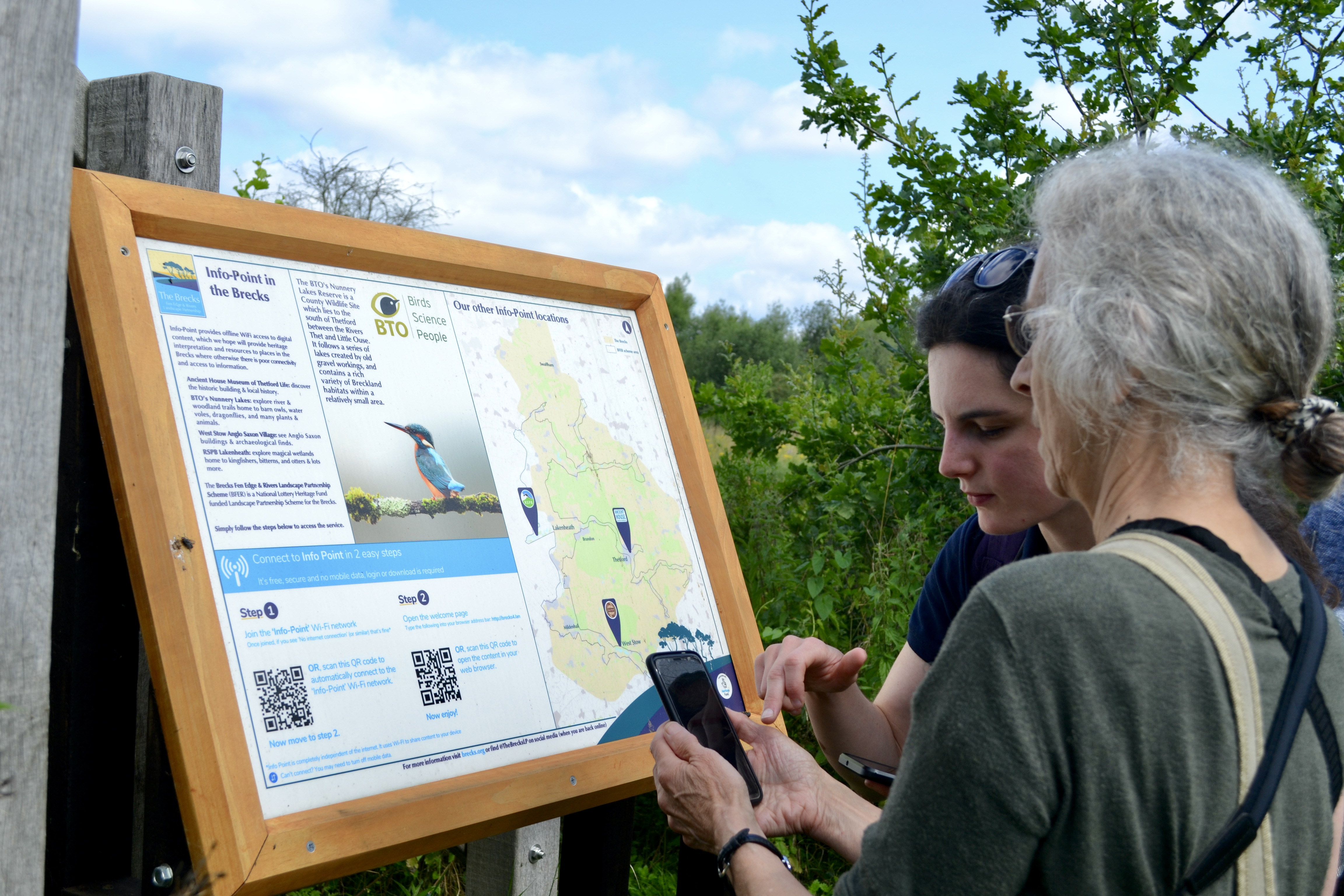 People using one of the four Info-Points