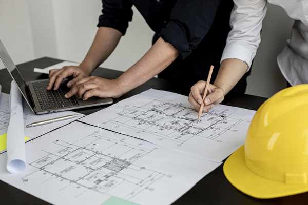 People looking over design blueprints