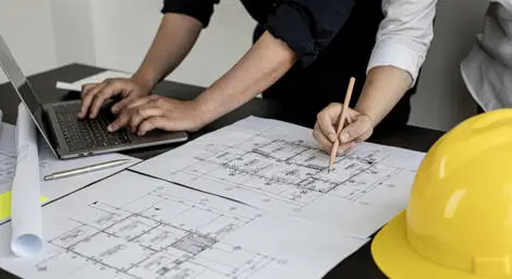 People looking over design blueprints