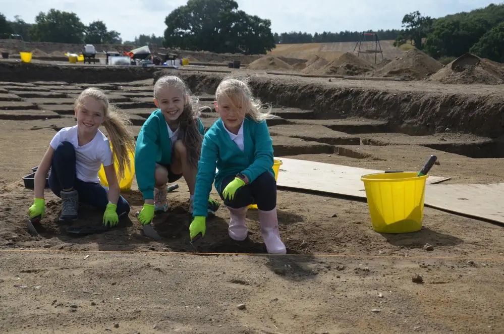 Children from Rendlesham Primary School excavating pits