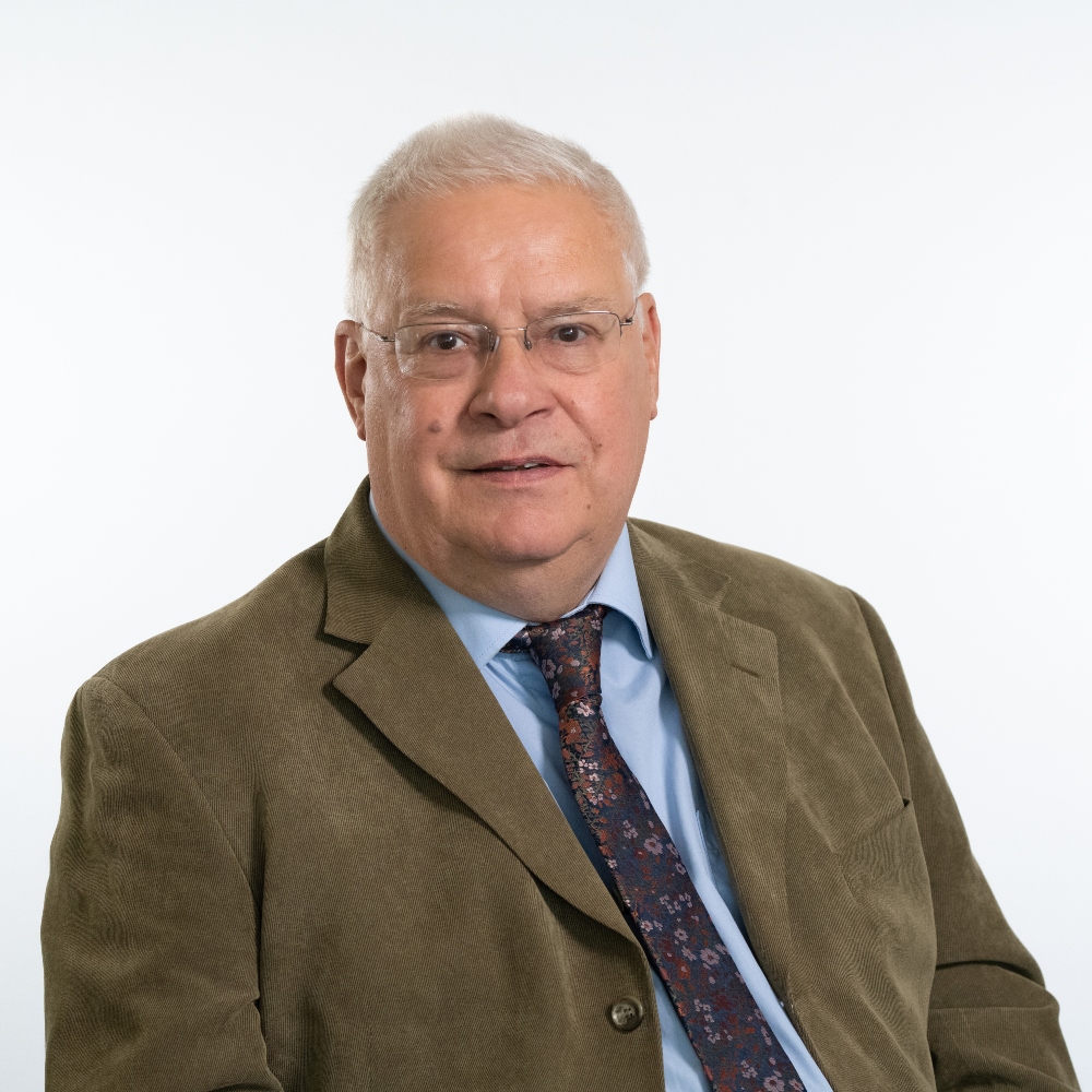 Councillor Chris Cox wearing brown jacket, shirt and tie
