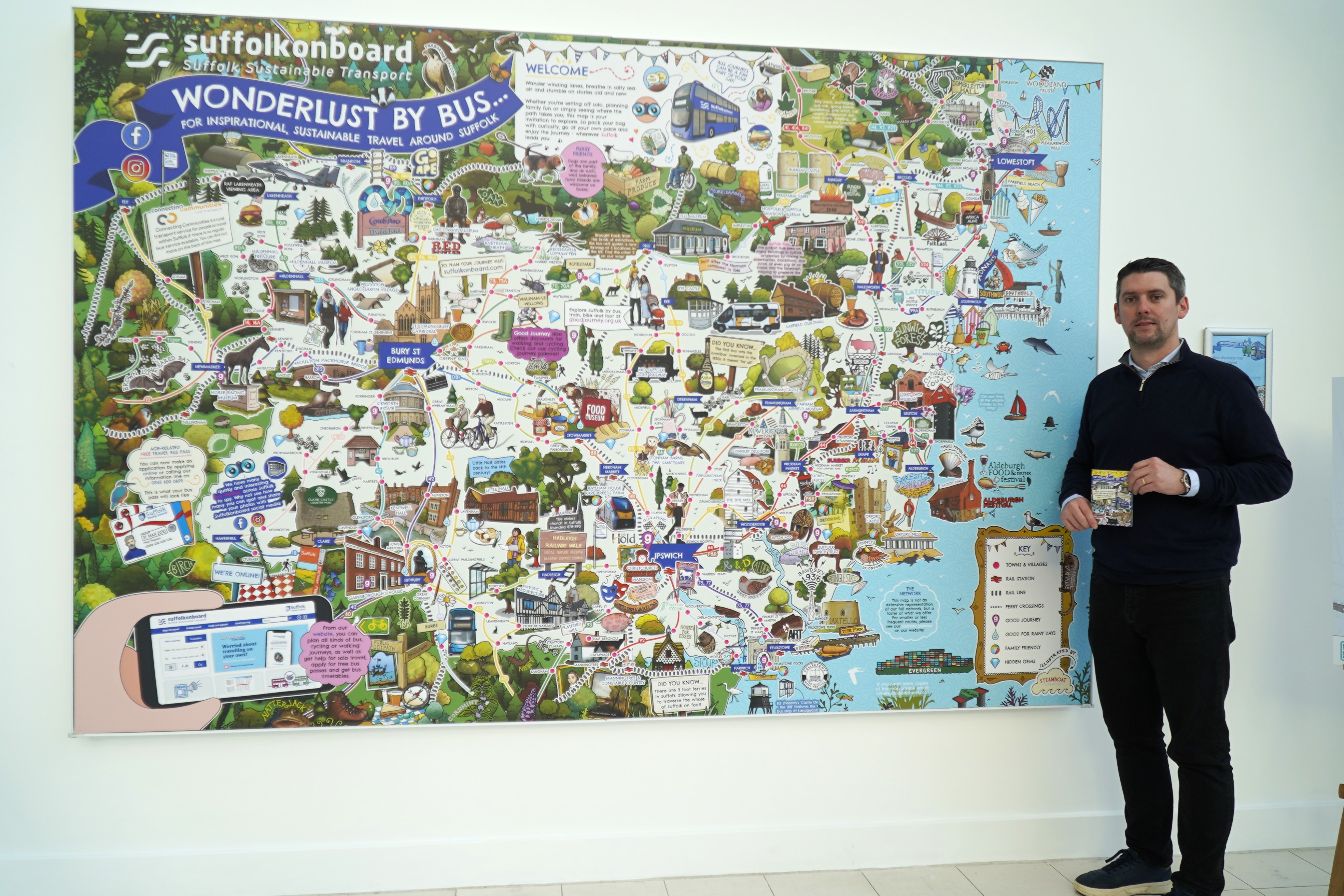 Cllr Chris Chambers with the Wonderlust by Bus map in Endeavour House
