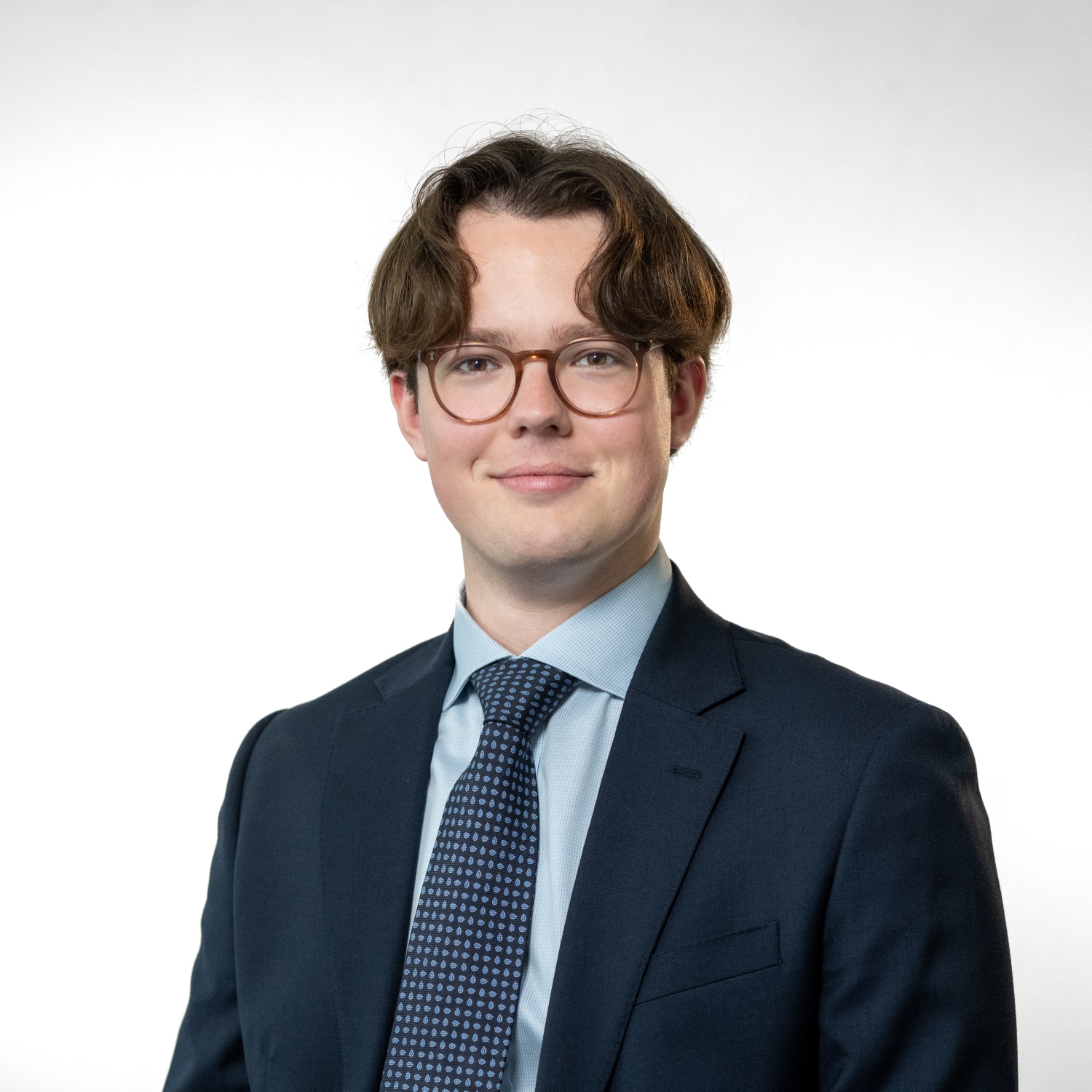Cllr Henry Lloyd Wearing glasses plus a dark jacket, light blue shirt and navy spotted tie.