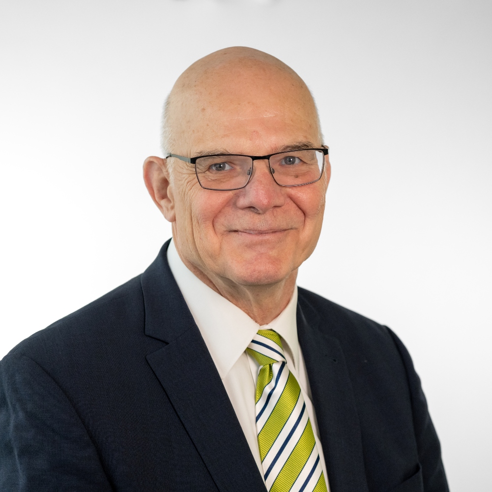 Councillor Martin Robinson wearing black suit and Green, white and black striped tie 