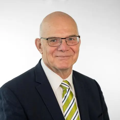 Councillor Martin Robinson wearing black suit and Green, white and black striped tie