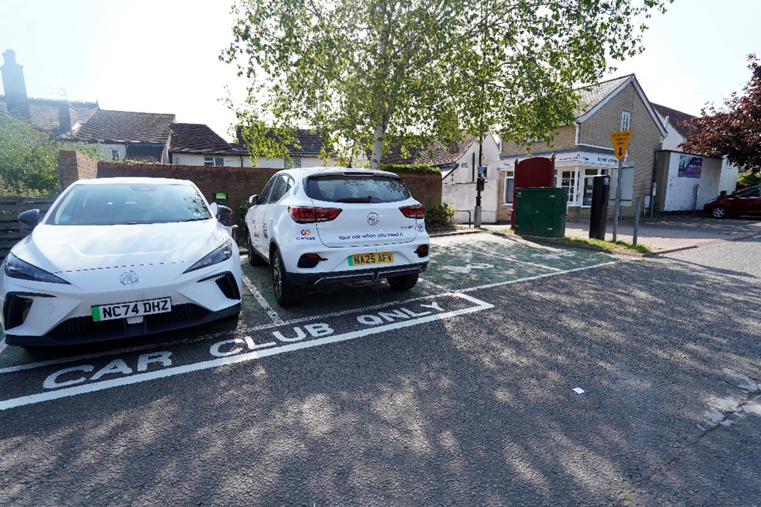 White cars parked in car park