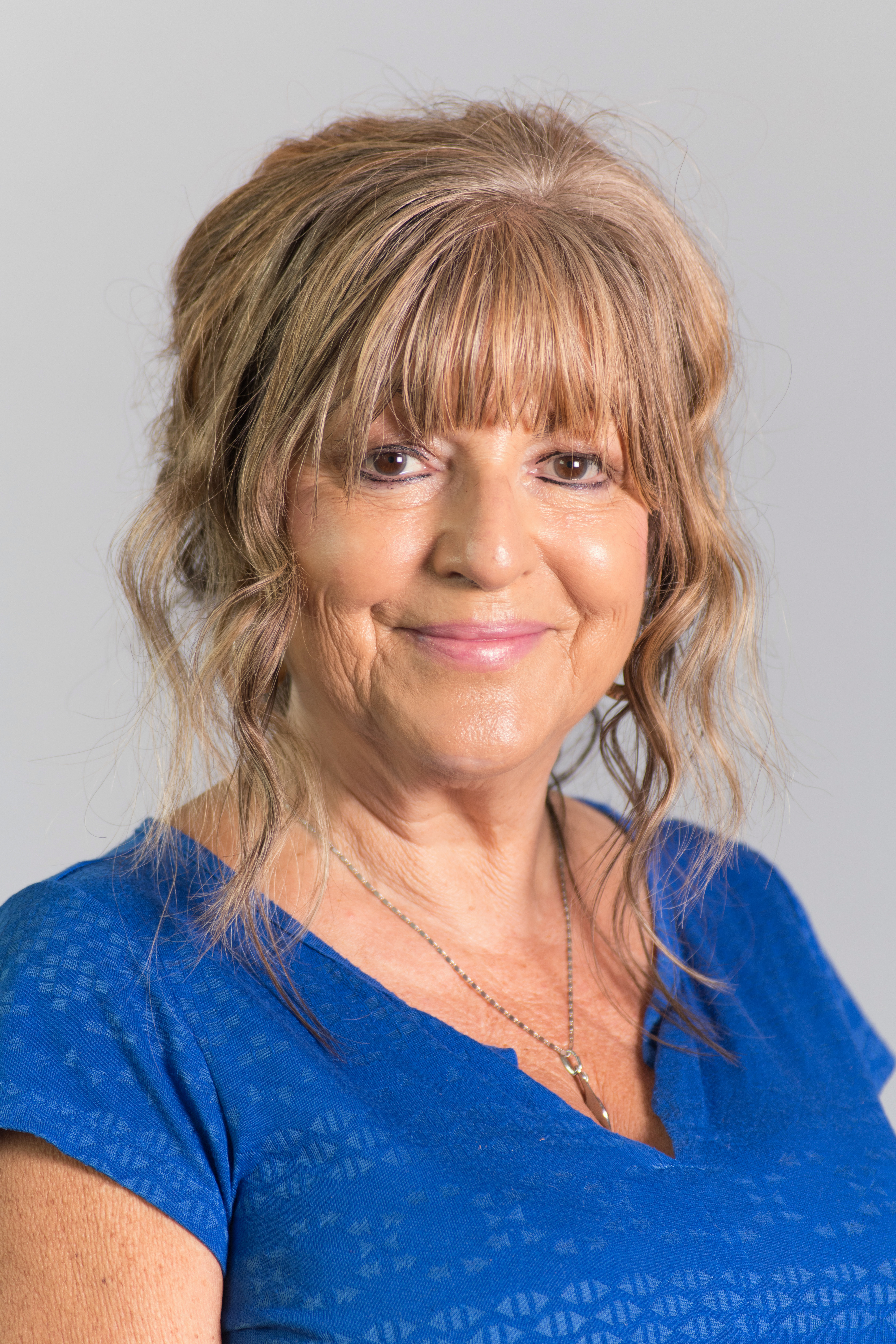 Councillor Nadia Cenci, wearing a blue top and smiling towards the camera.