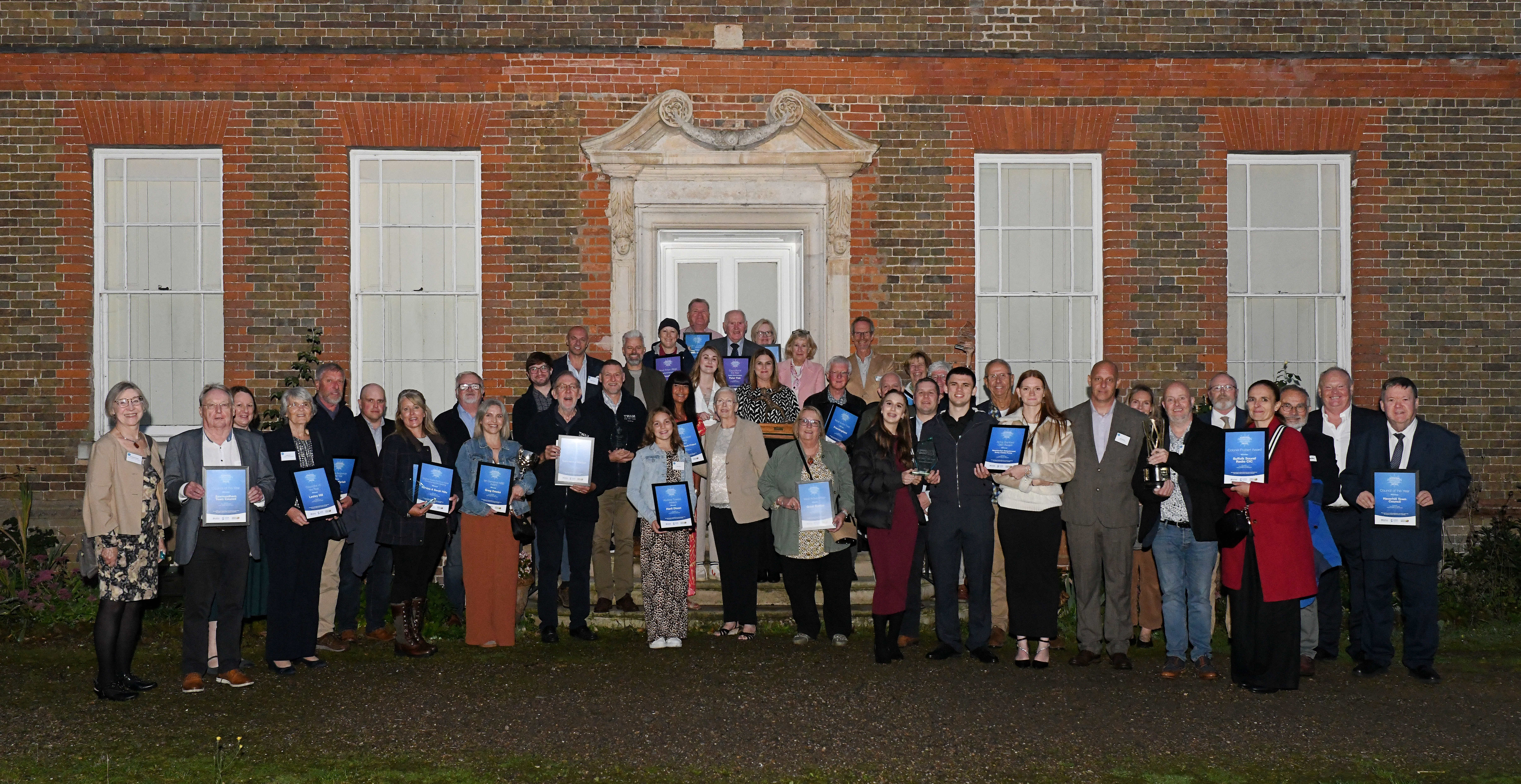 Group of people holding their winning certificates 
