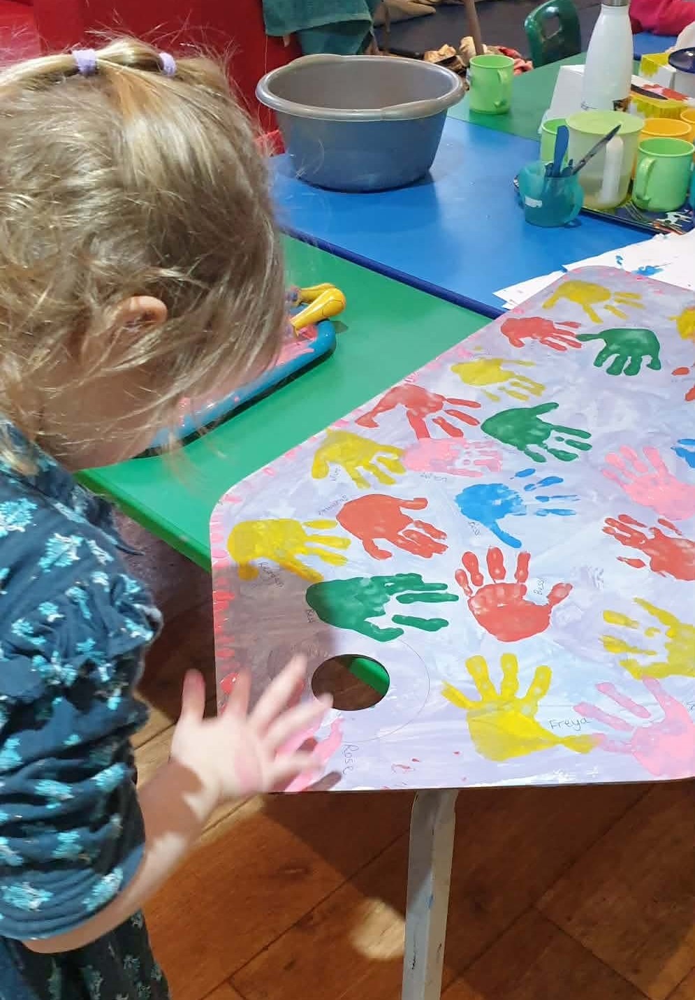 Child with hand print painting