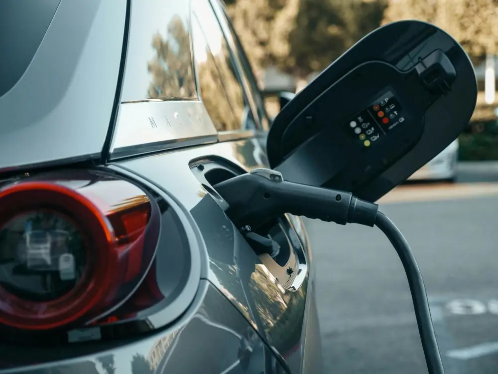 a charging cable plugged into an electric car