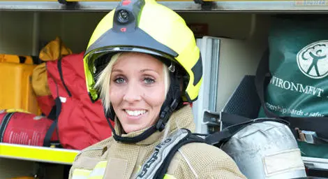 Firefighter standing in front of a fire engine