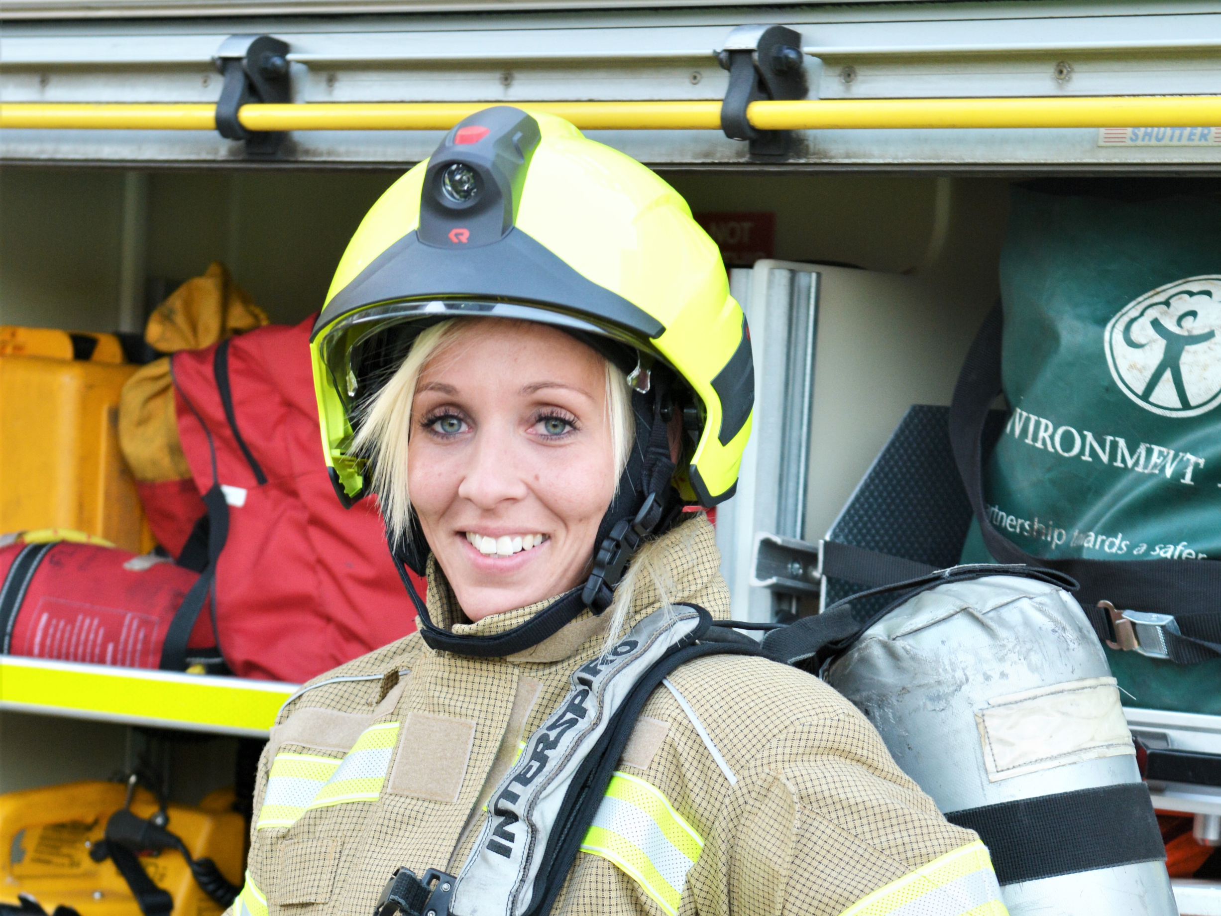 Firefighter standing in front of a fire engine