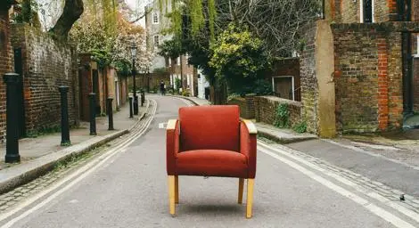 A red armchair abandoned in the street