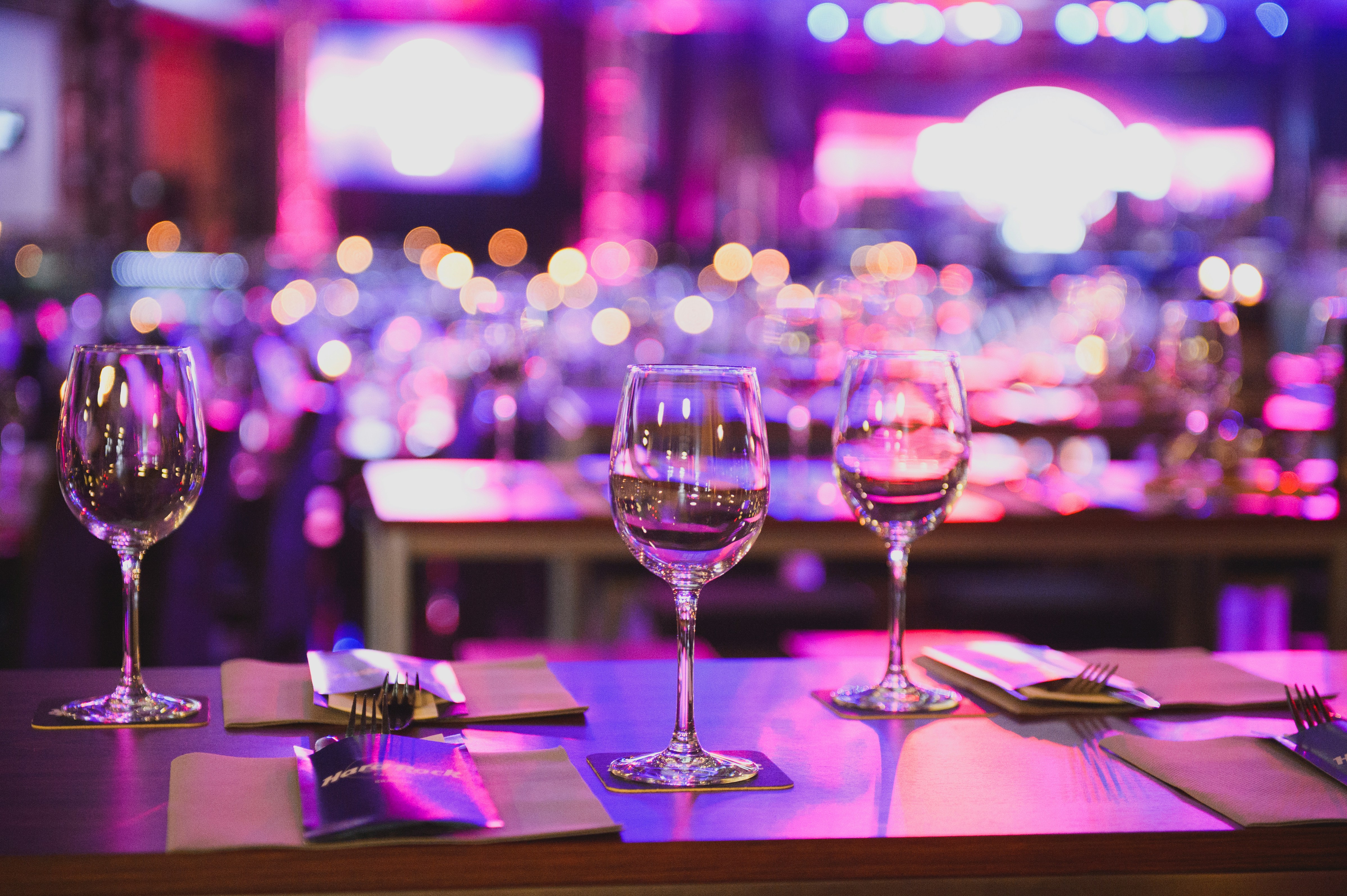 3 wine glasses are on a table in a restaurant