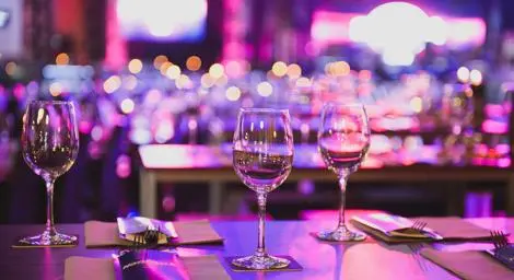3 wine glasses are on a table in a restaurant