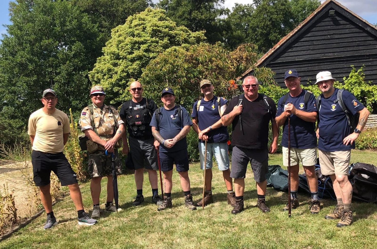 Eight men in shorts and T-shirts