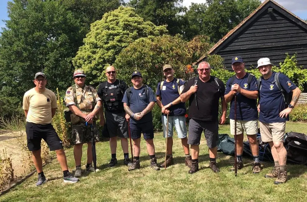 Eight men in shorts and T-shirts