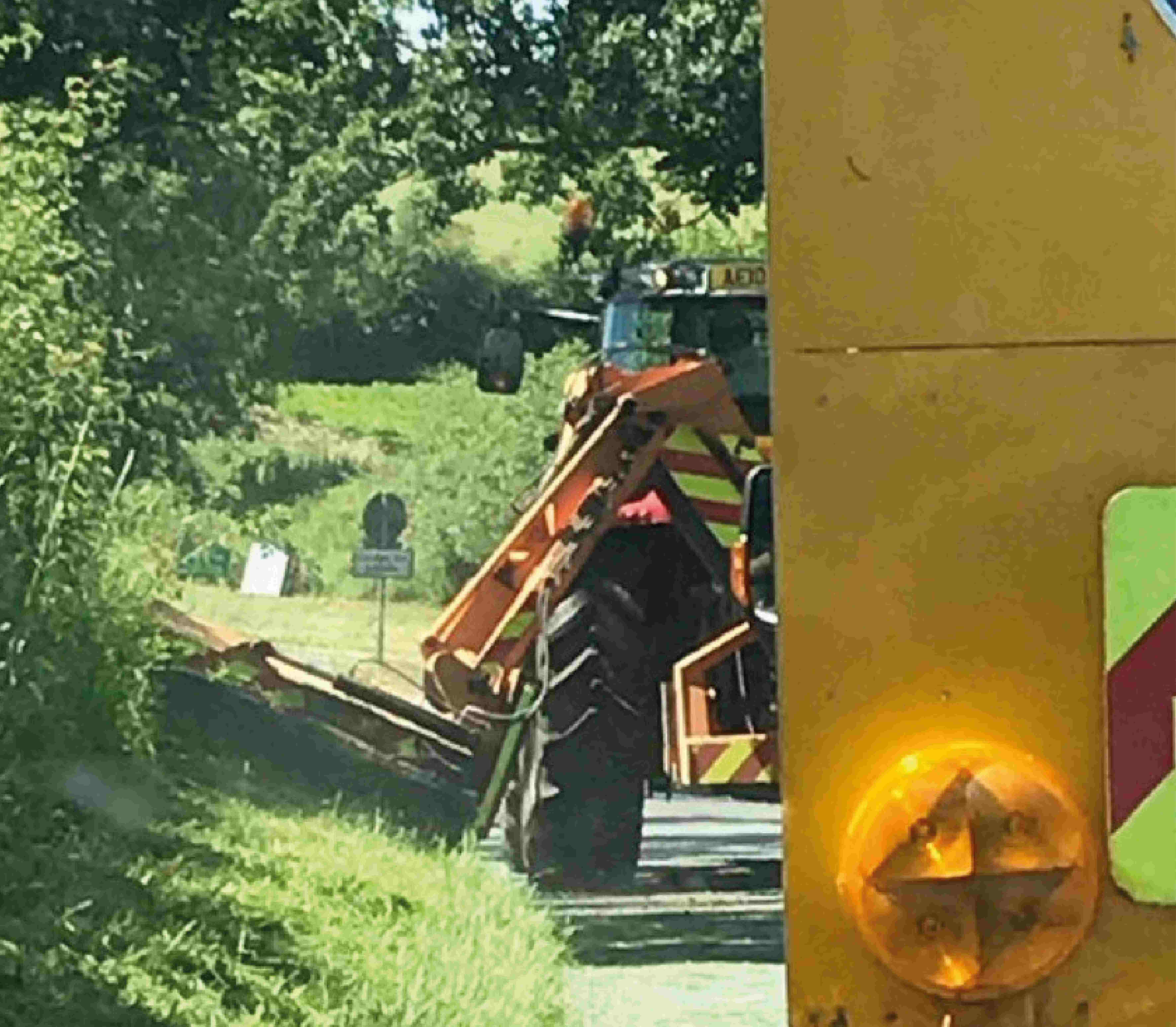 A grass cutter mowing a verge