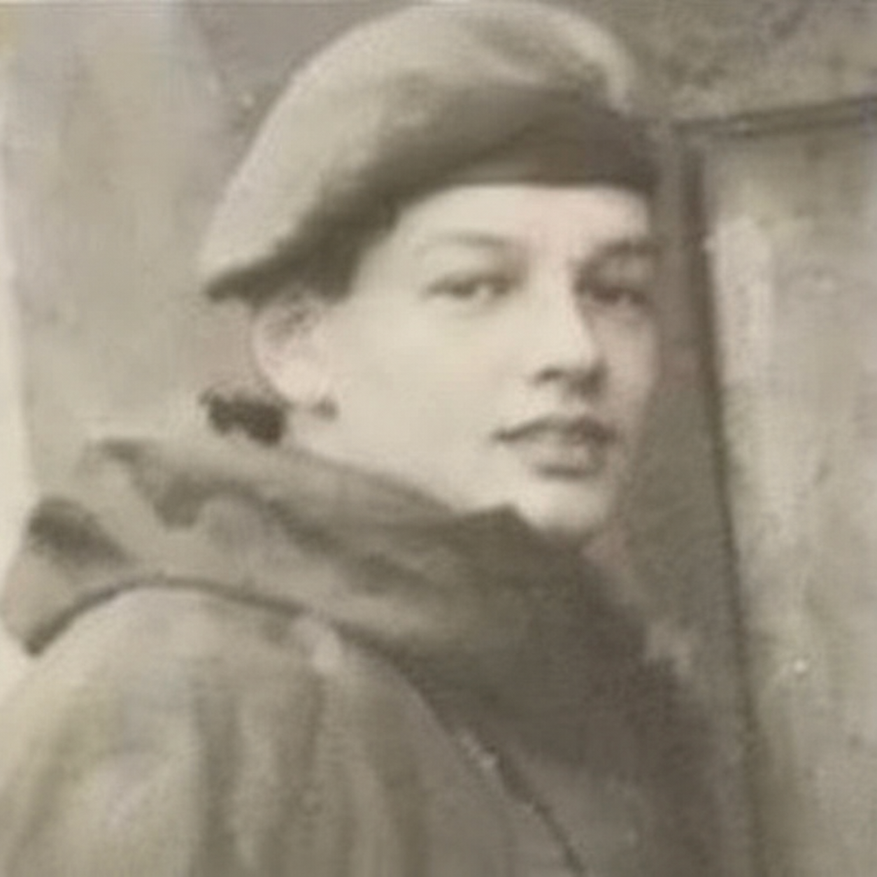 Black and white image of a young soldier wearing a beret