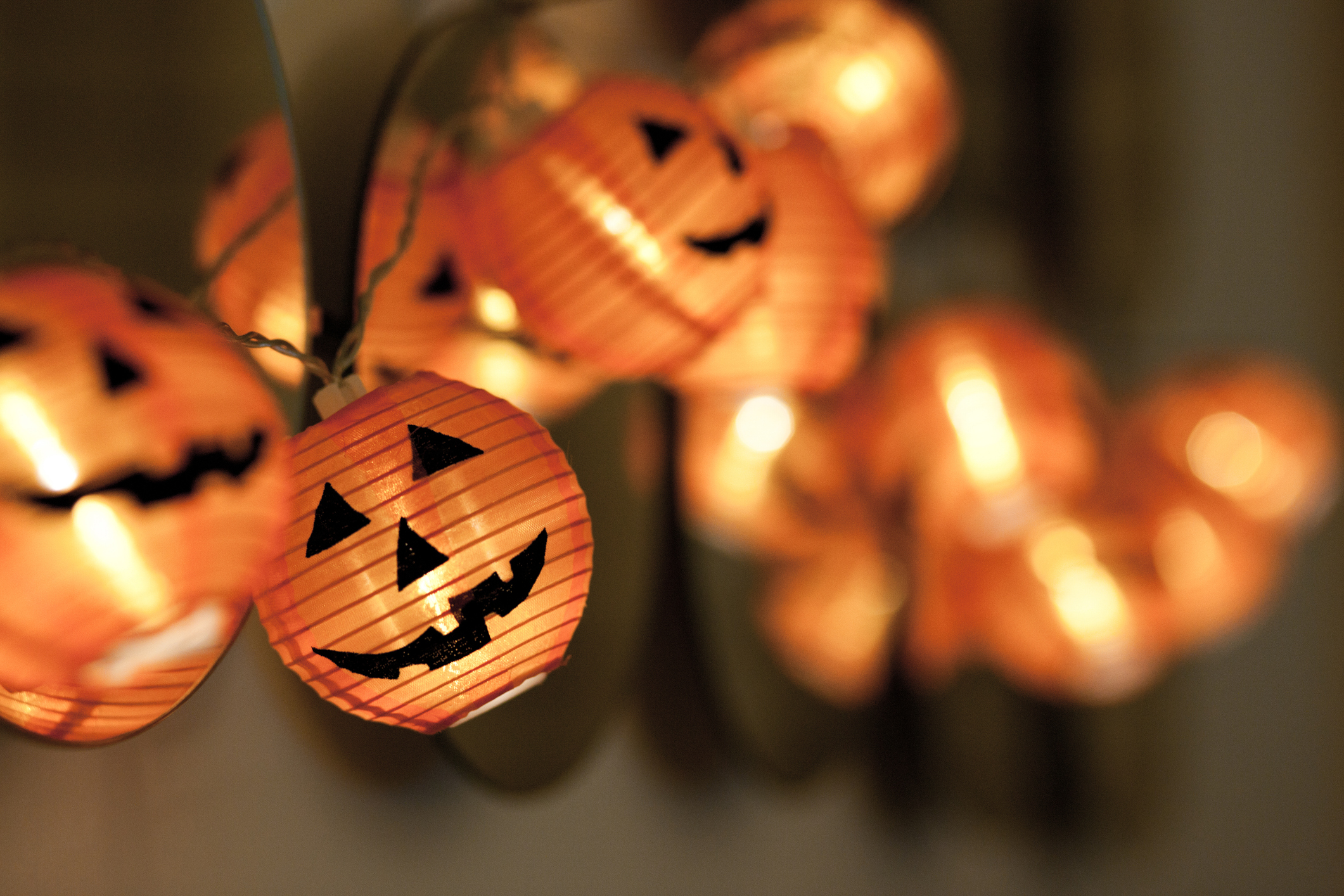 Close-up string of pumpkin lights moving out of focus