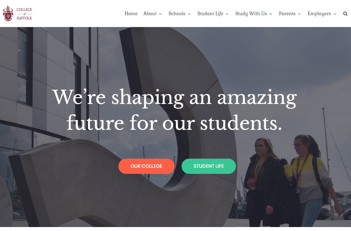 Picture of two students walking past an artwork on Ipswich Waterfront for the bogus website