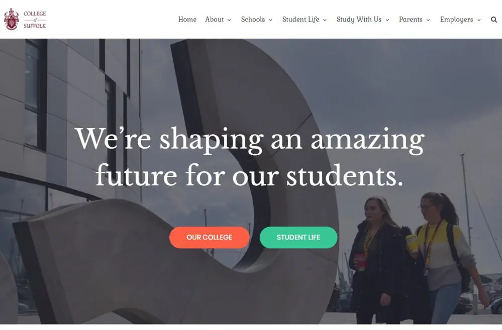 Picture of two students walking past an artwork on Ipswich Waterfront for the bogus website