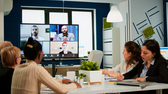 A team is conducting a hybrid meeting