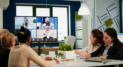 A team is conducting a hybrid meeting