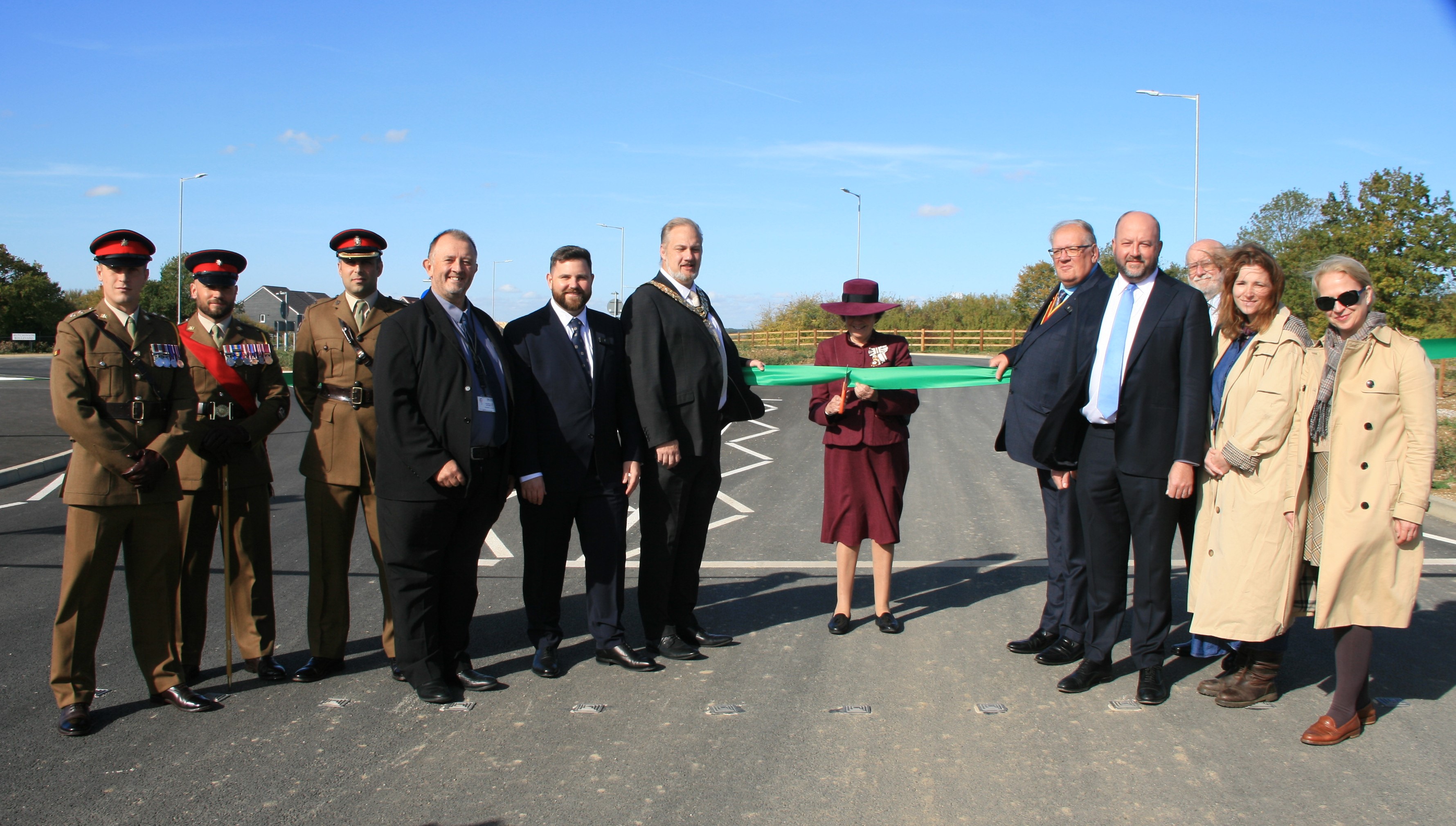 The Lord Lieutenant cuts a green ribbon with politicians and soldiers in dress uniform.